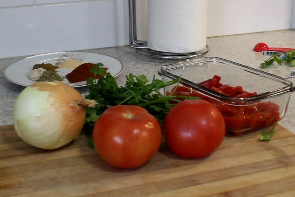 ingredients for the beef sauce lasagna recipe. Tomatoes, onion, fresh herbs and dry spices